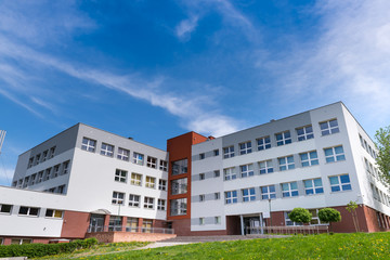 Public school building at sunny day, exterior view - obrazy, fototapety, plakaty