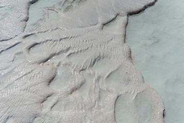 Snow-white salt deposits on the stone slopes created natural patterns.