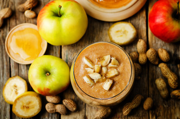 Naklejka na ściany i meble peanut butter smoothie with milk, chocolate, apples, banana and oats