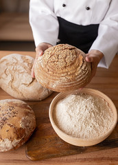 Crop little baker showing bread