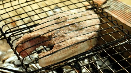 Close-up shot of delicious grilled tuna fish on barbeque grill. 4K