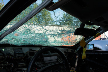 close-up of a completely broken car windshield view from the passenger compartment