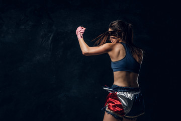 Beautiful sportive woman is warming up before training while posing for photographer. © Fxquadro