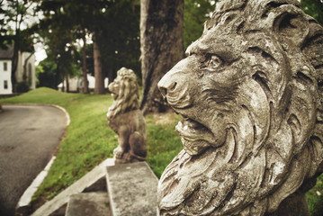 Fototapeta na wymiar Lions guarding the front steps of a home.