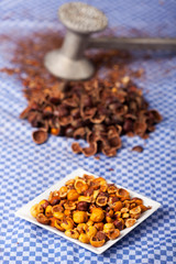 crushed hazelnuts with nutshells on a dish towel