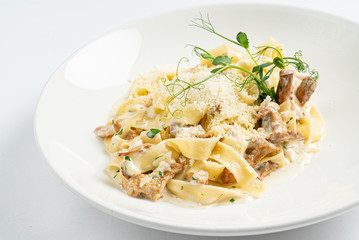 pasta with chanterelles on white plate