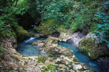 Naklejka premium blue mountain river with a waterfall