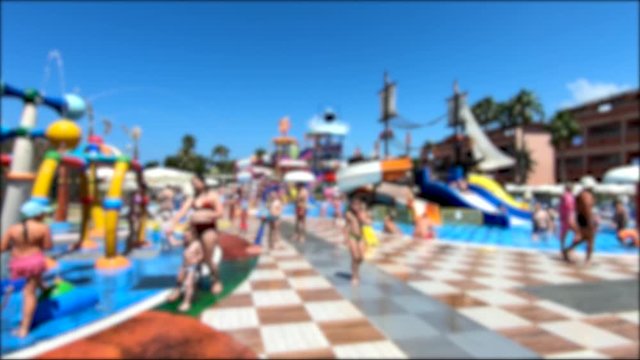 Aquapark slide with pool. Relaxation and sunbathing area.