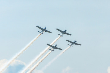 Airplanes on airshow. Aerobatic team performs flight at air show
