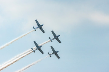 Airplanes on airshow. Aerobatic team performs flight at air show