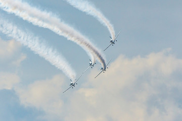 Airplanes on airshow. Aerobatic team performs flight at air show