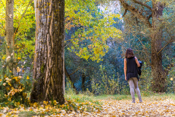 A young woman with a black T-shirt on the beautiful path of the Hoces del Duraton Natural Park in Segovia, Spain