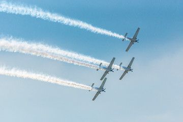 Airplanes on airshow. Aerobatic team performs flight at air show