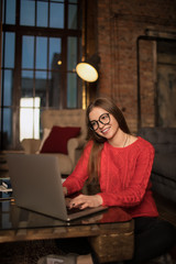 Happy smiling woman copywriter of homepage having conference via laptop computer, sitting in home....