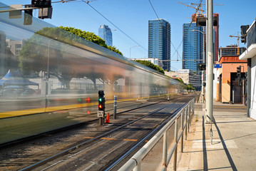 The light rail metro train speeding doen Flower St. in Los Angeles.