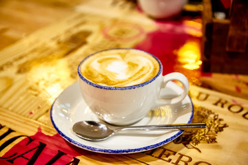 A Cup of cappuccino coffee is on the table
