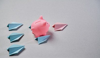 Start up and success. New business, aspirations, and investment concept. Piggy flying on paper...