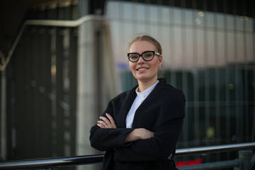 Portrait of cheerful confident woman leadership in stylish glasses and formal wear standing with...