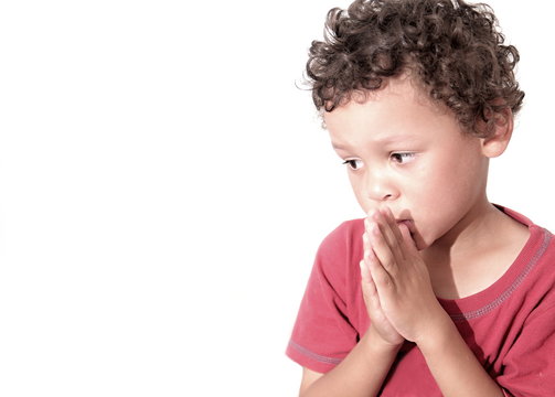 boy praying to God stock image with hands held together with closed eyes with white background stock image stock photo