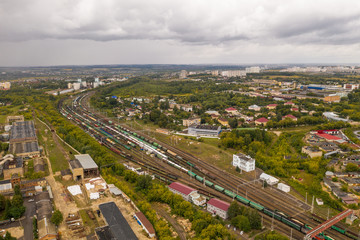 Industrial area with cargo trains on railroad, aerial view from above
