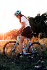 Fototapeta na wymiar young beautiful woman riding a bicycle in a park. Active people. Outdoors