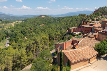 Fototapeta na wymiar The small village of Roussillon. Landscape with houses in historic ocher town Roussillon, Provence, France