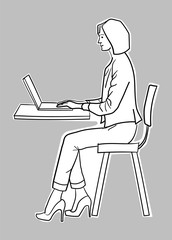 Young teacher browsing the internet through laptop inside the classroom