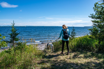 woman with dog next to lake