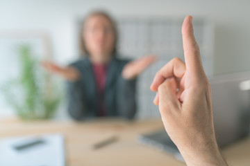 Boss threatening employee with finger in business office - obrazy, fototapety, plakaty