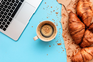 Coffee and croissants for messy breakfast in business office