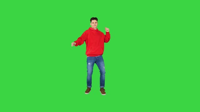 Hip-Hop style man in red hoody dancing on a Green Screen, Chroma Key.