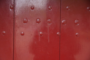 Fototapeta premium old red colored wood with many bolts