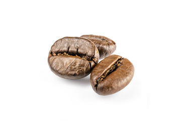 Three shiny fresh roasted coffee beans isolated on white background. Coffee background or texture concept.