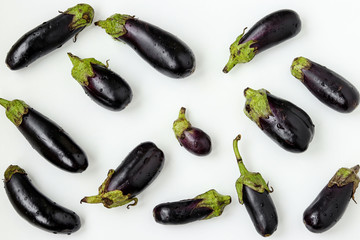 Organic eggplants scattered on white background, Organic food concept, horizontal orientation