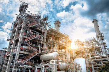 Fototapeta premium Oil and gas refinery plant form industry petroleum zone,Refinery equipment pipeline steel and oil storage tank at sunrise. -image