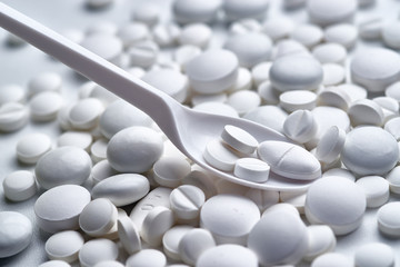 spoon in a pile of pills