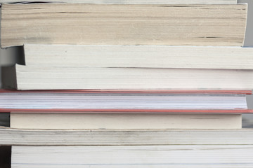 A large number of old books stacked on top of each other. Background shot, clean blank copy space