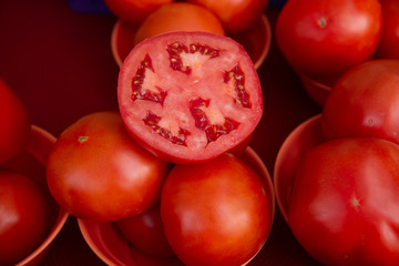 sliced and whole fresh tomatoes at farmers market