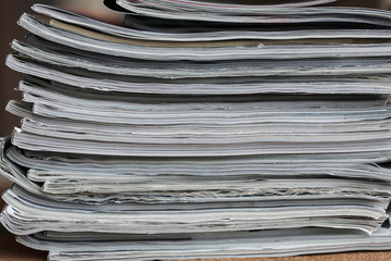 A stack of magazines, close-up macro filled the frame. A background for publishing or informational articles.