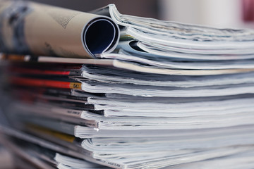 A stack of magazines, close-up macro filled the frame. A background for publishing or informational articles.