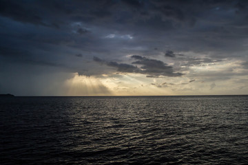 Sunset rays shining over the ocean