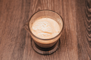 a cup of dark coffee with foam