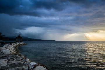 Rocky pathway towards gazebo by the shore