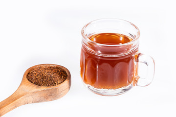 Black tea in a cup and dried and powdered leaves