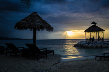 Gazebo by the beach with colorful sunset