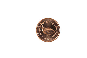 A ten fils coin from the United Arab Emirates isolated against a white background