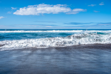 Fototapeta na wymiar Waves in Atlantic ocean on black sand Beach of Santa Barbara, Sao Miguel Island, Azores, Portugal