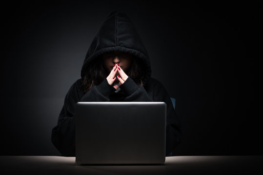 Female hacker hacking security firewall late in office