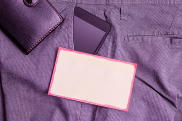 Smartphone device inside trousers front pocket with wallet and note paper