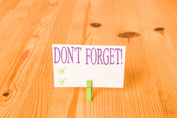 Writing note showing Don T Forget. Business concept for used to remind someone about important fact...